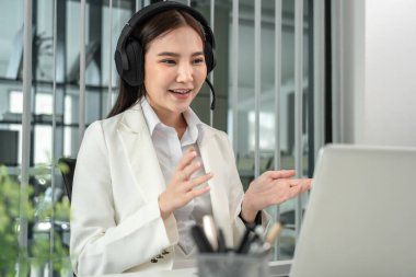 Female call center provides information to a customer calling for help, Contact us, Service with a beautiful and friendly voice, Long distance communication, Talk using headphones or headsets.