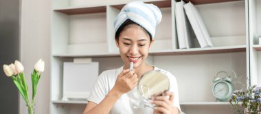 Half Japanese woman putting on makeup and hair to prepare for work in the morning, Facial care and cosmetics, Make up mirror,  Take a shower and put on make-up and get dressed and ready to go to work.