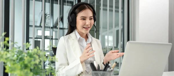 Female call center provides information to a customer calling for help, Contact us, Service with a beautiful and friendly voice, Long distance communication, Talk using headphones or headsets.