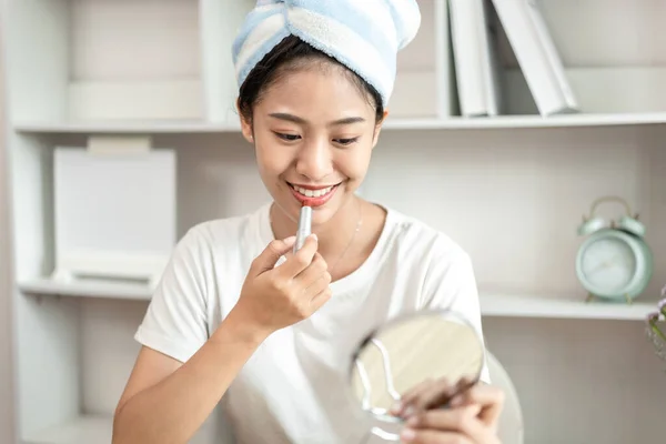 Half Japanese woman putting on makeup and hair to prepare for work in the morning, Facial care and cosmetics, Make up mirror,  Take a shower and put on make-up and get dressed and ready to go to work.