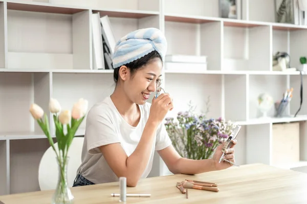 Half Japanese woman putting on makeup and hair to prepare for work in the morning, Facial care and cosmetics, Make up mirror,  Take a shower and put on make-up and get dressed and ready to go to work.