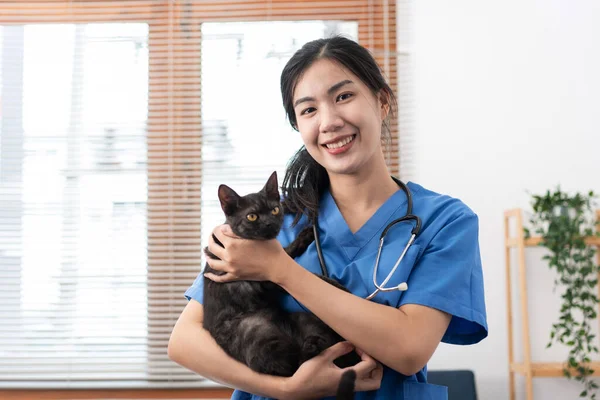 Veterinarian Woman Blue Uniform Playing Lovely Cat Hugging Stroking While — Stockfoto