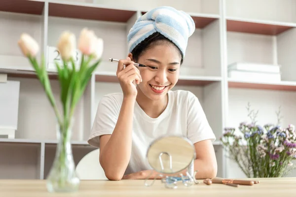 Half Japanese woman putting on makeup and hair to prepare for work in the morning, Facial care and cosmetics, Make up mirror,  Take a shower and put on make-up and get dressed and ready to go to work.