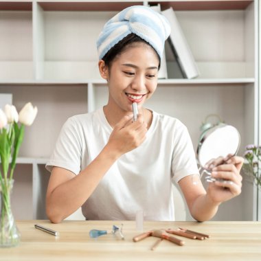 Half Japanese woman putting on makeup and hair to prepare for work in the morning, Facial care and cosmetics, Make up mirror,  Take a shower and put on make-up and get dressed and ready to go to work.