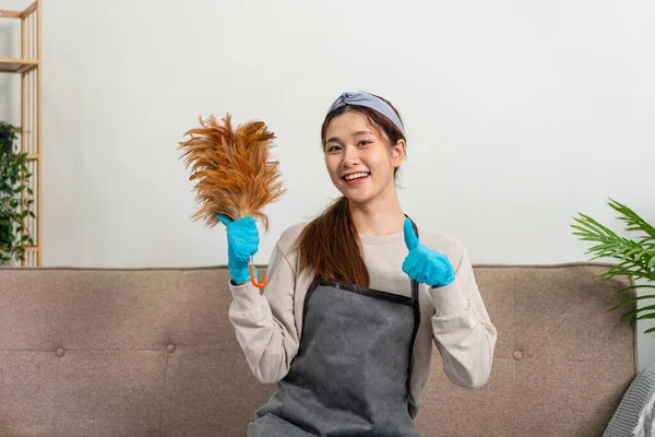 Housekeeper Wearing Protective Gloves Holding Feather Duster Showing Happy Thumbs — Fotografia de Stock