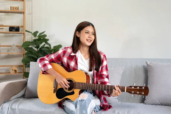 Jovem Está Tocando Guitarra Prática Para Cantar Música Enquanto Senta — Fotografia de Stock