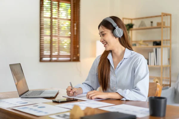 Female Freelance Reading Business Data Laptop Writing Information Notebook While — Stock Photo, Image