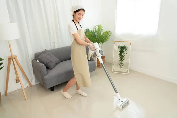 Housekeeper Using Vacuum Cleaner Cleanups Vacuuming Dirt Living Room While — Stock Photo, Image