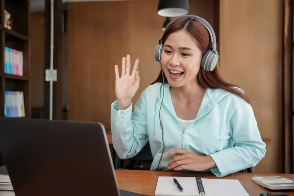 Female Student Headphone Using Laptop Greeting Classmate Video Call While — Stock Photo, Image