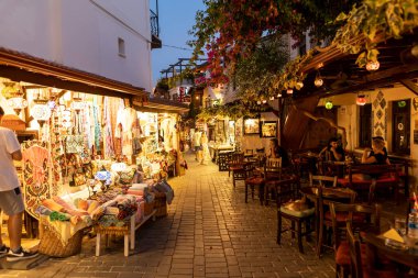 Ka, Antalya  Turkey - 07.02.2022: Night photo of people wandering in narrow streets of Ka.