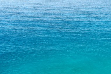 Close up photo of blue and green toned sea surface as a background.