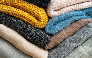 Stack of clothes with different colours and materials.