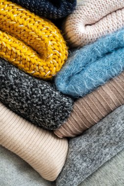 Stack of clothes with different colours and materials.