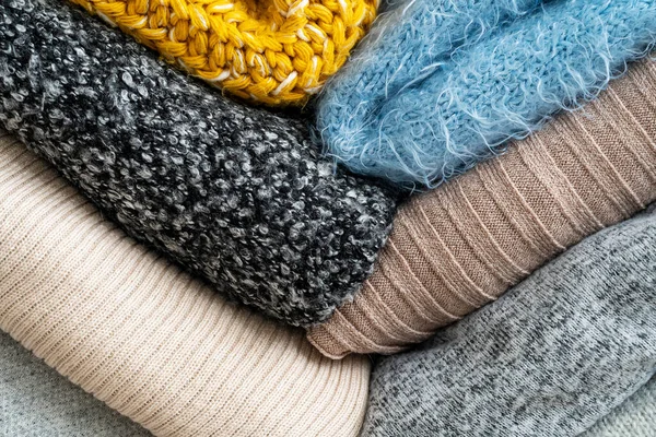 Stack of clothes with different colours and materials.