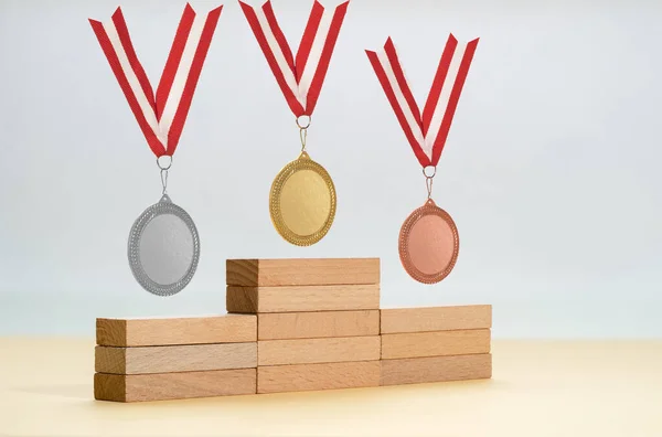 Platform made of wooden blocks and gold silver and bronze medals as a symbol of first second and third winners.