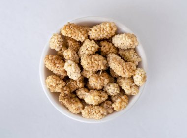 Close up photo of dried raw mulberry on isolated background.