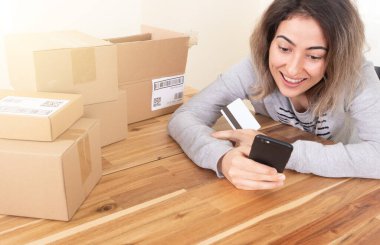 Woman shopping online while sitting at home.