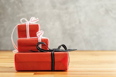 Close up photo of  red gift box  with white ribbon. Love, gift and present concept.