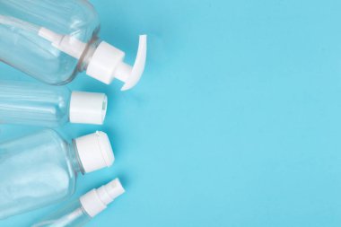 Used coronavirus materials lays on blue isolated background. Waste management and medical pollution concept.