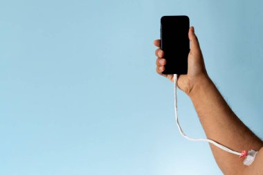 Close up photo of a hand charging mobile phone