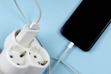 Close up photo of a hand charging mobile phone