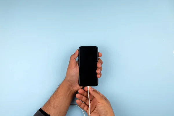 Close up photo of a hand charging mobile phone