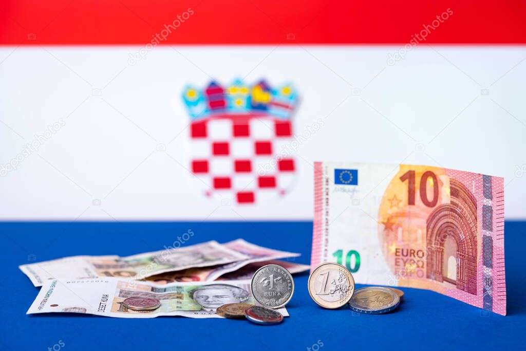 Croatian currency, kuna, together with Euro coins and 10 Euro banknote. Croatia adopted a European currency theme with the Croatian flag motif in the background.