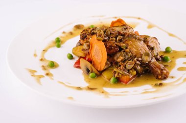 Baked duck leg in sauce with vegetables