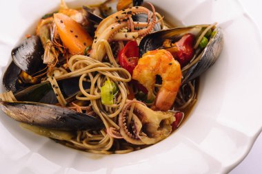 Seafood pasta spaghetti with prawns, squis, mussel and tomatoes