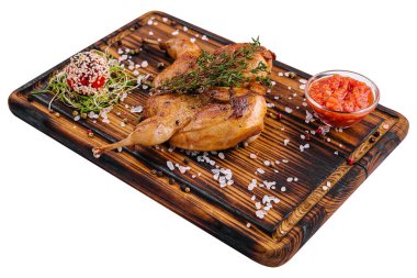 Roasted partridge with sauce tomato on wood board