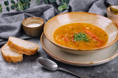 Traditional chicken noodle soup in a brown bowl