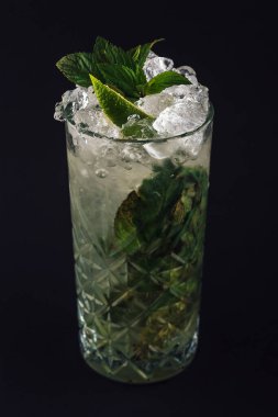 Mojito kokteyli ve koyu arkaplanda taze nane.