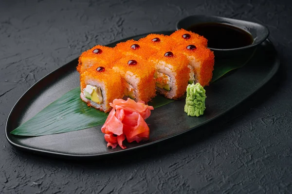 Sushi california roll on black dish