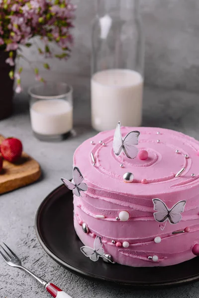 pink cake decoration in the form of butterflies