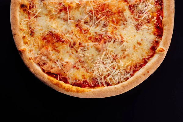 tasty pizza margarita on black background
