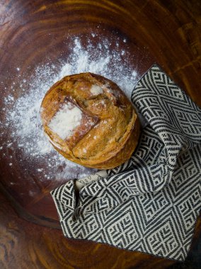 Italian bread with cloth with African illustration on white flour and wooden background