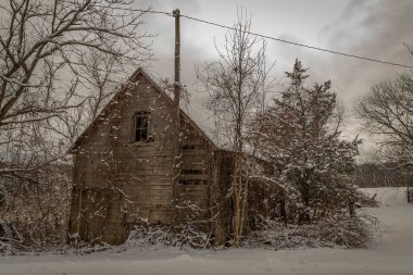 Abandoned farm building on a snowy winter morning