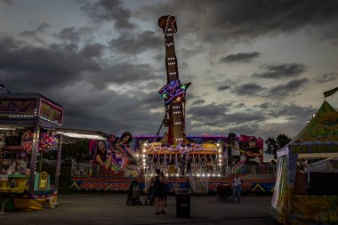 Midway of a county fair before a thunderstorm