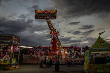 Midway of a county fair before a thunderstorm