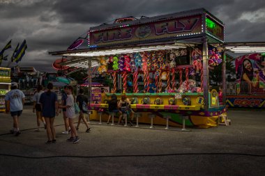 Midway of a county fair before a thunderstorm