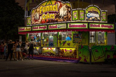 Midway of a county fair before a thunderstorm
