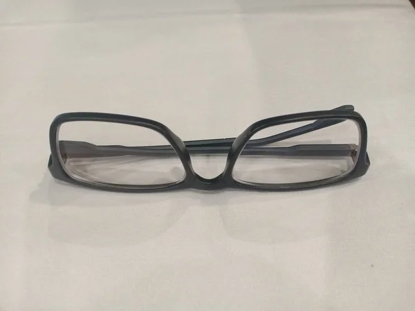 a glasses with metal frame down side