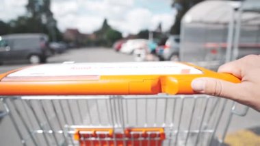 Going back with shopping cart to the stall in the supermarket parking lot. High quality 4k footage