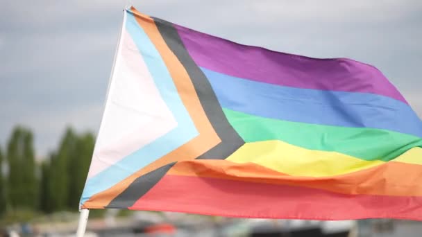 LGBTQ rainbow flag in a residential harbour area european city closeup. High quality 4k footage