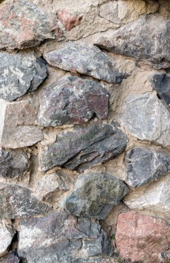 a section of a decorative wall made of natural stone bonded with cement