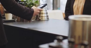 PIN kodunu girmeden kredi kartı ödeyen kadının yakın plan fotoğrafı, akıllı ödeme, ulaşılamaz ödeme, e-para, dijital para. Tıbbi maskeli barmen kadın, Cavid 'den sonra iş tekrar açıldı.