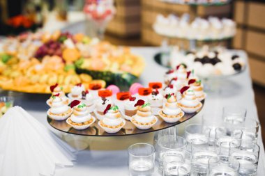 Çeşitli lezzetli tatlılar, yemek fikirleri ve kutlamalarla dolu bir büfe.