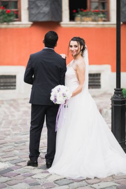 Sevgi dolu bir düğün çifti Lviv şehrinin sokaklarında yürüyor..