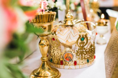 Kilisedeki masanın üzerinde altın taçlar var..