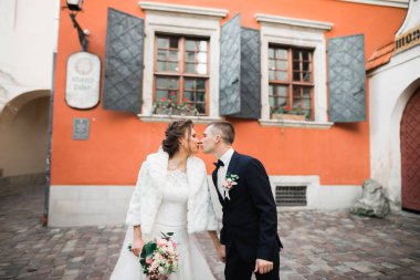 Güzel gelin ve damat evlendikleri gün kucaklaşıp öpüşüyorlar..